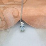 Delicate Aquamarine Diamond Pendant featuring octagon cut Aquamarine with scattering of diamonds in 18ct White Gold worn on a fine belcher chain