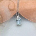 Delicate Aquamarine Diamond Pendant featuring octagon cut Aquamarine with scattering of diamonds in 18ct White Gold worn on a fine belcher chain