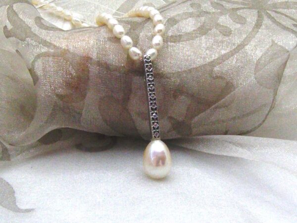 Pretty Allumette Pearl Pendant with Diamonds set with Drop Shape Freshwater pearl ~ designed in 9ct White Gold ~ shown on Rice Shape Freshwater Pearls but available on 9ct white gold chain if you prefer?  Diamond Weight ~ 0.09 carats,   Pendant length ~ 40mm