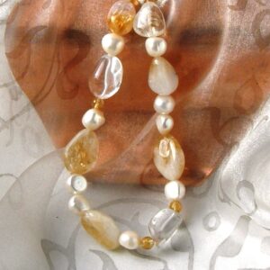 This Baroque Freshwater Pearl Necklace has been enhanced by Baroque Shape Candy Citrine & Rock Crystal in an asymmetrical pattern and finished with a feature bolt ring in Sterling Silver.