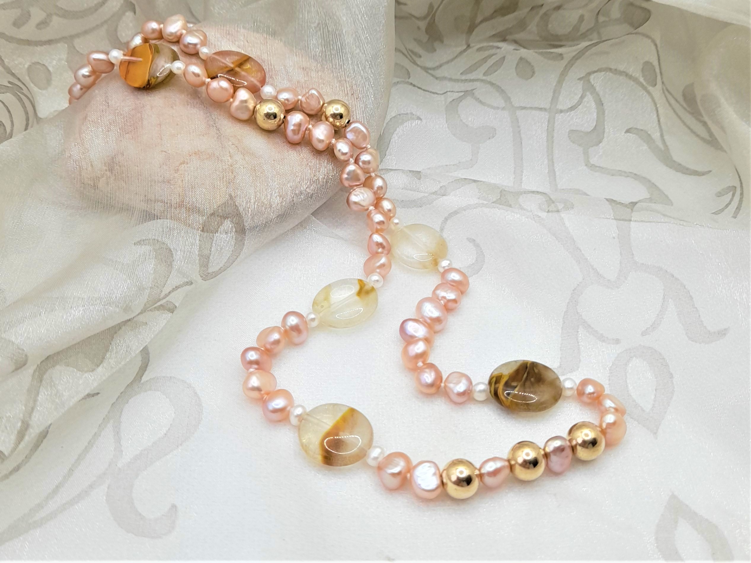 Subtle Pink Freshwater Pearl Necklace enhanced with the warm tones of pebble shape Banded Agate, with gold bead detail by Pearl Perfect.