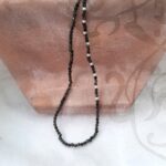 Delicate Freshwater Pearl Necklace designed with a pattern of White Freshwater Pearls scattered in an asymmetrical pattern through faceted Obsidian beads by Pearl Perfect Design Room.