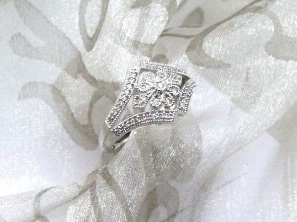 The Jasmine Diamond Ring is Designed in 18ct White gold - Diamond Weight 0.25 carats. This Pretty Floral Style Ring is pave set with Accent Diamonds and Millegrain Edge Detail for that Vintage Look.