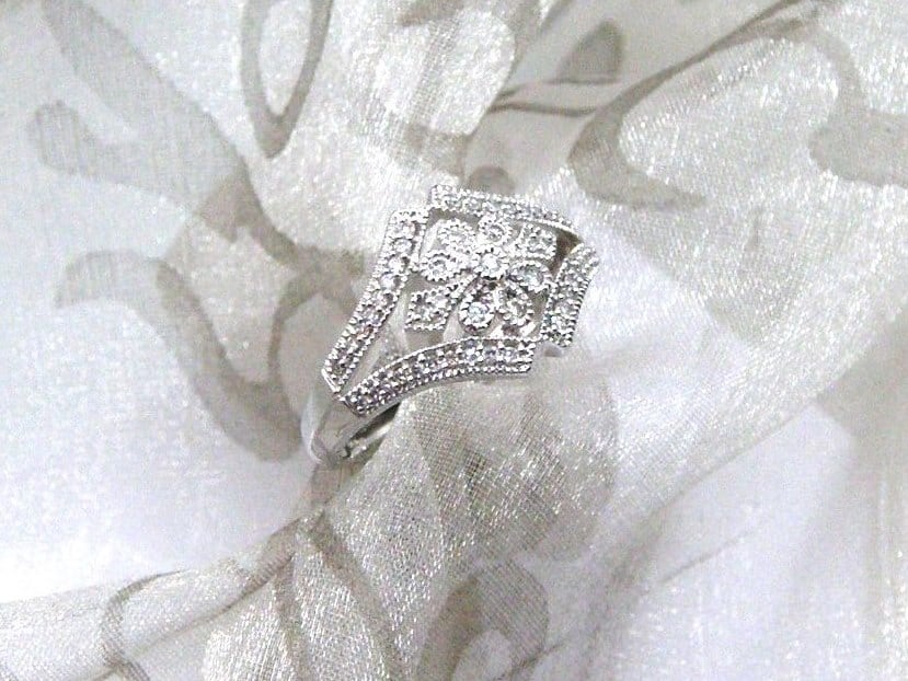 The Jasmine Diamond Ring is Designed in 18ct White gold - Diamond Weight 0.25 carats. This Pretty Floral Style Ring is pave set with Accent Diamonds and Millegrain Edge Detail for that Vintage Look.