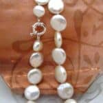 Freshwater Button shape Pearl Necklace fitted with a Sterling Silver feature bolt ring to compliment shape of the pearls.