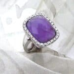 Stunning Amethyst Diamond Ring set with Checkerboard Frosted Amethyst in a pretty lilac colour.  The outline cushion shape is castelle set with Accent Diamonds & bead shoulder detail.  Designed in 18ct White Gold - Diamond Weight 0.26 carats.