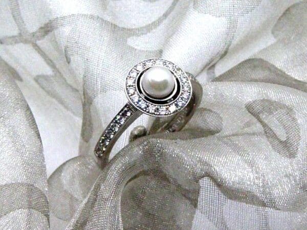 Delightful Pearl Diamond Ring set with Cultured Pearl & pave set diamond halo and shank to half hoop level. The Millegrain Edge detail gives that Vintage look.