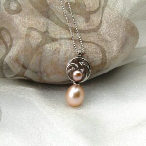 Pretty Circles Pearl Pendant with Diamonds set with Drop & Button Peach Freshwater Pearls & accent diamonds designed in 9ct White Gold. Sonja peach drop pearl measures 9mm - Pendant length 25mm - worn on 9ct white gold fine rollo chain.
