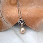 Pretty Circles Pearl Pendant with Diamonds set with Drop & Button Peach Freshwater Pearls & accent diamonds designed in 9ct White Gold. Sonja peach drop pearl measures 9mm - Pendant length 25mm - worn on 9ct white gold fine rollo chain.