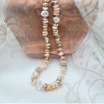 Pretty warm Peach & Plum colours in this Freshwater Pearl Necklace showcase the varied shapes of non-nucleated pearls, typically called Keshi by Pearl Perfect.