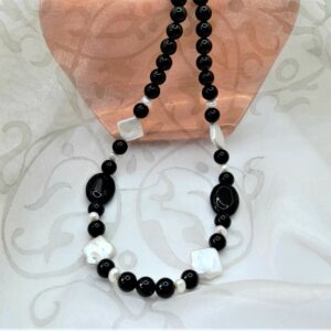 Onyx Freshwater Pearl Necklace, the feature Freshwater Pearls are square in shape contrasting with the oval and round highly polished Onyx beads. The necklace is finished with a Sterling Silver Clasp.