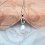 Ellesse Pretty Freshwater Pearl Pendant designed with Pave set Diamond looped knot and featuring drop White Pearl - Diamond Weight 0.07carats.