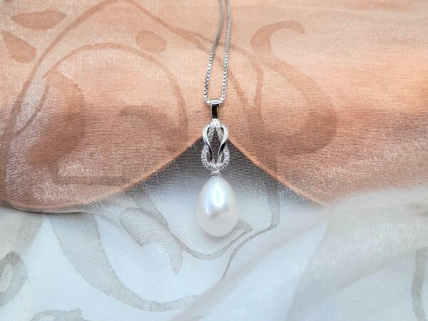 Ellesse Pretty Freshwater Pearl Pendant designed with Pave set Diamond looped knot and featuring drop White Pearl - Diamond Weight 0.07carats.