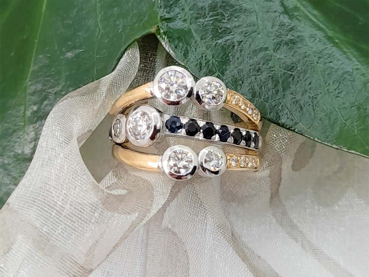 Paige one of our Bespoke Sapphire Diamond Rings,   Custom made in 18ct Yellow and White Gold as an Engagement Ring & Wedding Ring all in one. Sapphires and two larger diamonds were client's own from existing pendant with additional brilliant cut diamonds added to complete the design.
