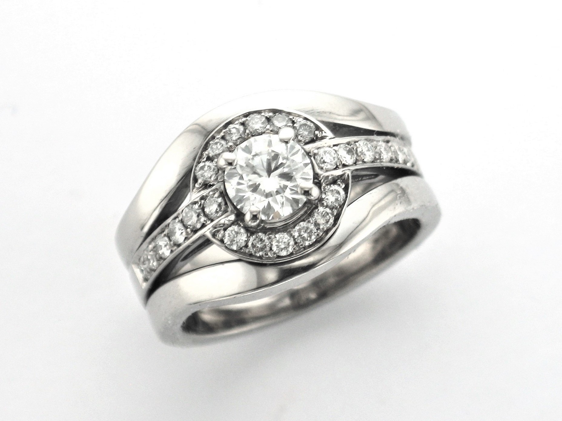 Stunning Wedding Ring designed using Client’s existing wedding bands with a new Brilliant Cut Diamond set halo centre.