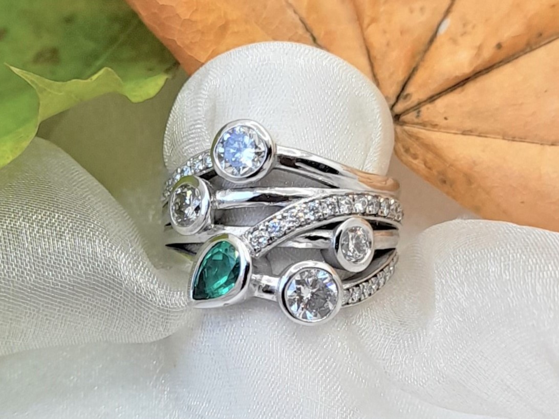 Signature Brook Wave Ring Designed with Garnet, Aquamarine, Tourmaline & Diamonds as one of our Family Rings with Birthstones.    The Gemstones were chosen to compliment each other's muted tones with tapering Brilliant Cut Diamonds & Pave set Diamonds added for sparkle.